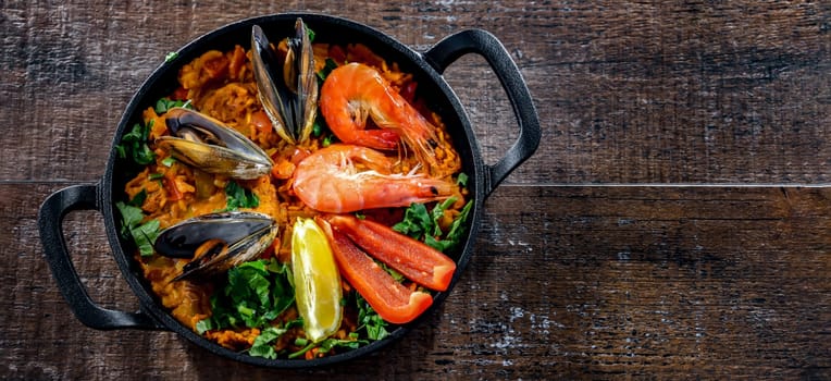 Seafood paella served in a cast iron pan.