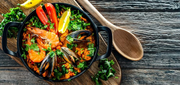 Seafood paella served in a cast iron pan.