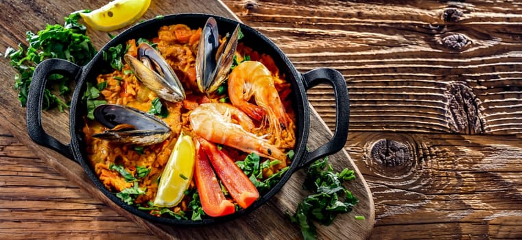 Seafood paella served in a cast iron pan.
