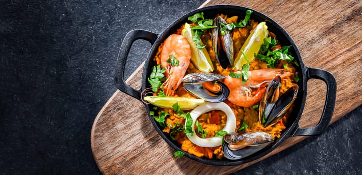 Seafood paella served in a cast iron pan.