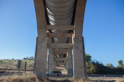 Vehicule crossing under Acedera Aqueduct through N430 National Road. Motion blurred