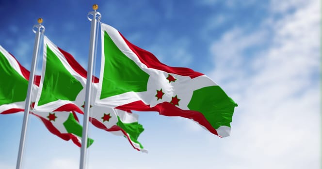 National flags of Burundi waving on a clear day. White diagonal cross dividing into red and green sections, three green stars in the center. 3d illustration render. Fluttering fabric. Selective focus