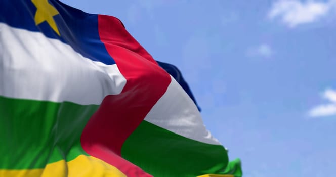 National flag of Central African Republic waving on a clear day. Blue, white, green, and yellow stripes with a red stripe in the middle and a yellow star in the canton. 3d illustration render. Fluttering fabric