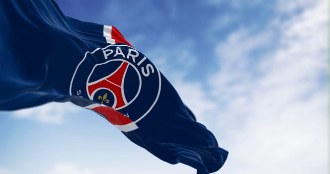 Paris, FR, July 20 2023: Paris Saint Germain football club waving on a clear day. French professional football club based in Paris. Illustrative editorial 3d illustration render. Selective focus