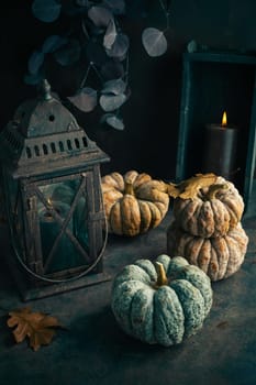 Fall candle decoration with  pumpkins, wooden home decor still life scented candle, autumn season interior decoration details