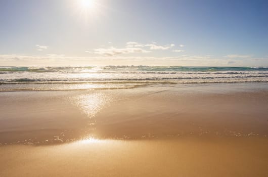 Empty conceptual background with copyspace for advertising surfing holiday vacation Sunshine Coast Queensland sun surf sandy beaches. Early morning rising sun over ocean.