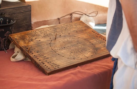 Reenactor reading annual roman calendar and zodiac. Divination methods in ancient rome