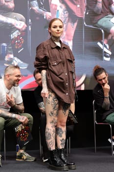 Krakow, Poland - June 11, 2022: Unidentified participant during the contest for the best tattoo at the 15th Tattoofest Convention in Cracow. One of the most prestigious tattoo festivals.