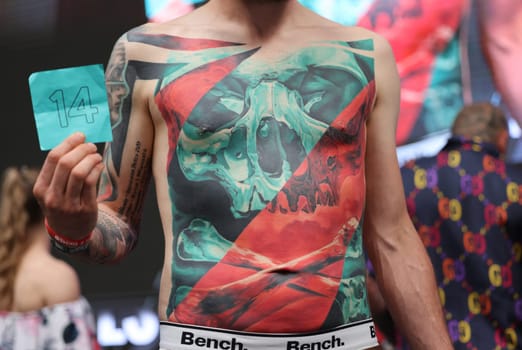 Krakow, Poland - June 12, 2022: Unidentified participant during the contest for the best tattoo at the 15th Tattoofest Convention in Cracow. One of the most prestigious tattoo festivals.
