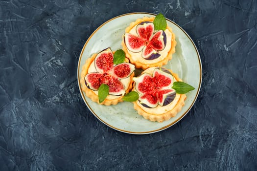 Tasty tartlets with curd cream and figs. Sweet tartlets with fresh berries.