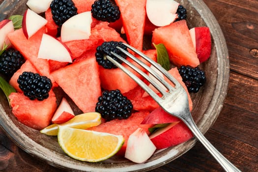Salad of watermelon, blackberry and peach. Summer fruit diet salad. Top view