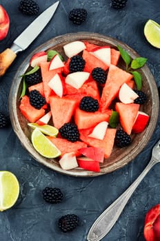 Salad of watermelon, blackberry and peach. Summer fruit diet salad. Top view