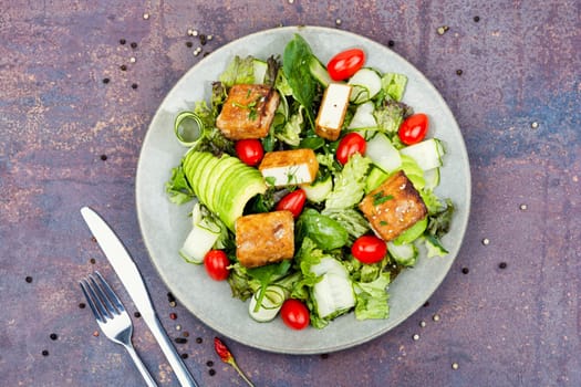 Unusual salad with fried halloumi cheese, vegetables and herbs