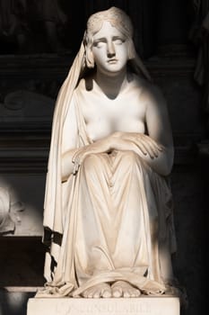 Pisa, Italy - June 2023: catholic cemetery, antique statue of sad woman, by Lorenzo Bartolini, 1841
