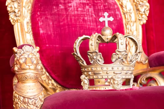 Ancient crown on red velvet. Antique symbol of authority, luxury, monarchy, nobility, success