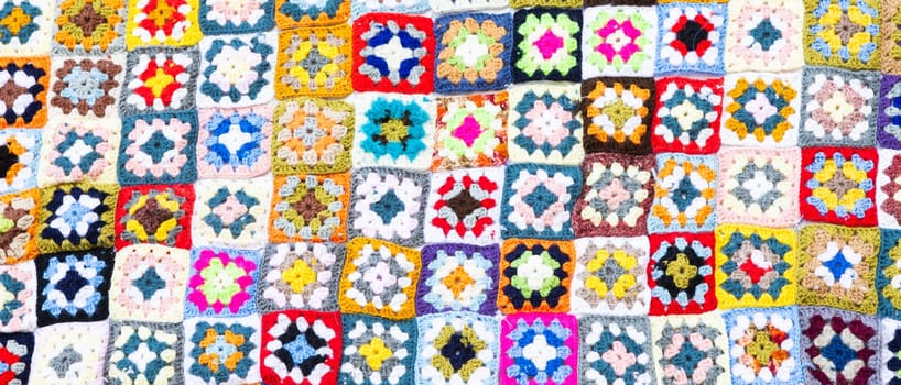 Multi colored blanket in wool, geometric background, retro decorative pattern