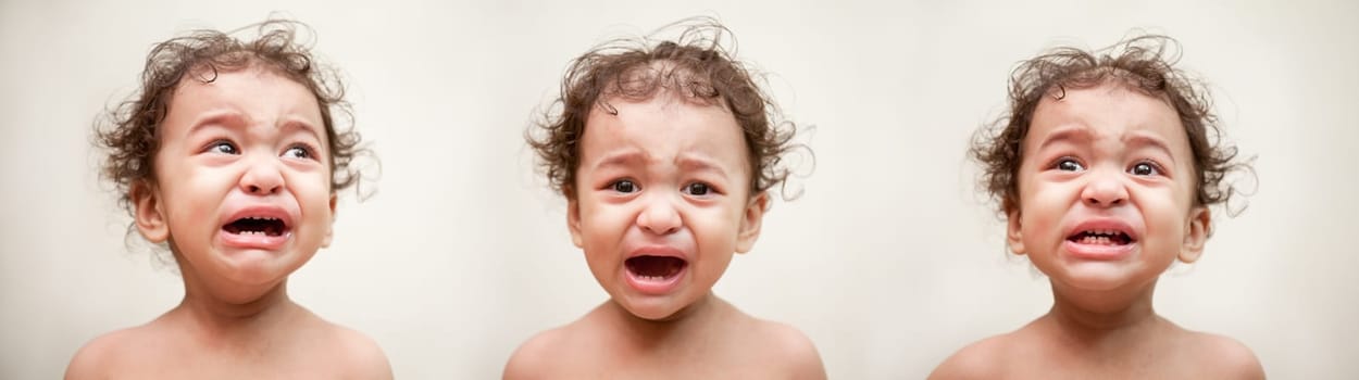 Adorable Indian baby crying a over white background