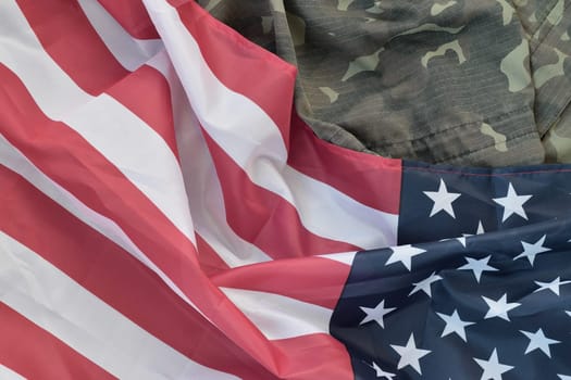 United States of America flag and folded military uniform jacket. Military symbols conceptual background banner for american patriotic holidays design