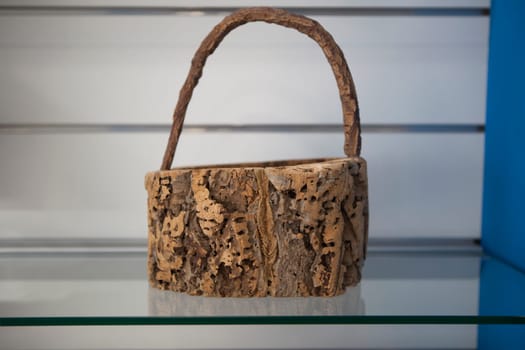 Vila Nova, Portugal - Jul 26th, 2023: Basket made of cork. Alentejo crafts displayed at tourist office, Vila Nova de Milfontes, Portugal