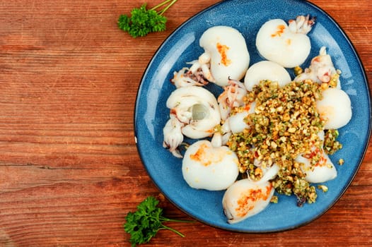 Fried squid or calamari served with nut salad. Roasted whole calamari.
