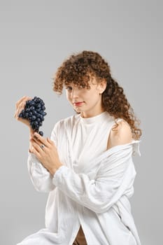 Portrait of cute woman with bunch of grape
