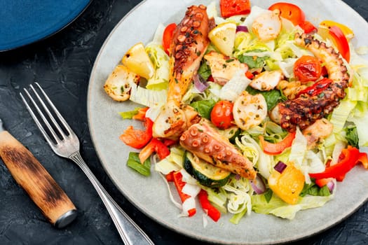 Salad of fresh vegetables and octopus tentacles. Octopus salad. Healthy food