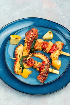Skewers of octopus, squid and vegetables. Seafood on the skewers, pieces of suckling octopus kebab