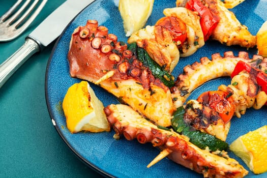 Skewers of octopus, squid and vegetables. Seafood on the skewers, pieces of suckling octopus kebab