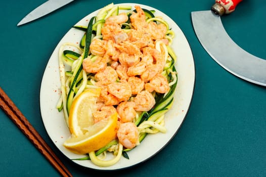 Healthy food, shrimp on a vegetable side of zucchini on white plate. Asian food.