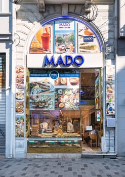 Istanbul, Turkey - May 13, 2023: Storefront of Mado Cafe in Istiklal street, with a variety of food on display in the window. The cafe is known for delicious Turkish cuisine, including Turkish delight