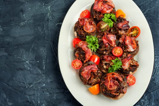 Appetizing champignon mushrooms stuffed with turkey, ground turkey,and bacon. Close up