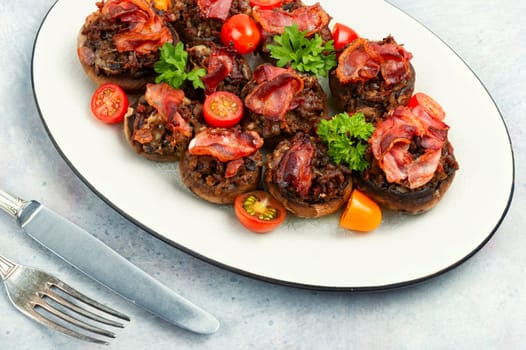 Appetizing champignon mushrooms stuffed with turkey, ground turkey,and bacon. Close up
