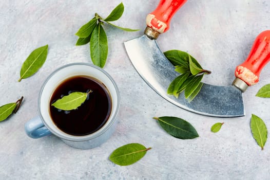 Cup of freshly tea with bay leaves. Bay leaf infusion. Herbalism. Flat lay.