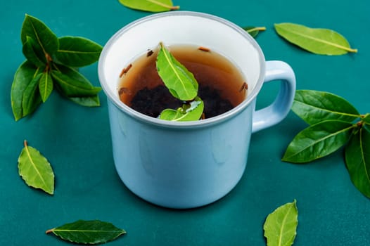 Cup of freshly tea with bay leaves. Bay leaf infusion. Herbalism. Flat lay.