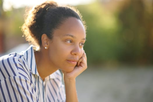 Black woman contemplating sitting in a park