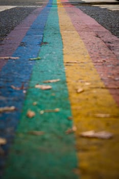 Closeup shot of rainbow colored zebra crossing indicating equal rights for lbgtq community
