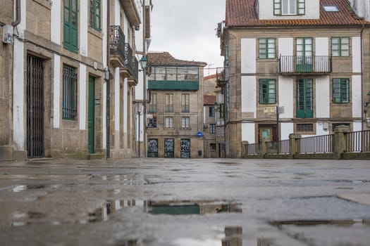 Santiago de Composteal, Spain, September 11th 2023: Low angle view on the wet streets of Santiago de Compostela during a rainy day