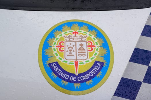 Santiago de Composteal, Spain, September 11th 2023: Santiago de Compostela logo on the hood of a police car.
