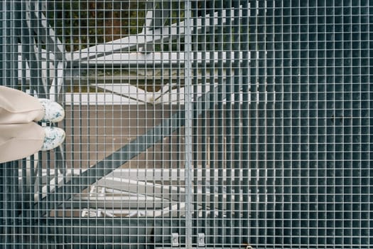 Walking on Air: Legs and feet on Hanging mesh Observation Deck.