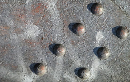 Steel rivets, rivets on an iron beam. Texture of a steel beam and rivets in arrangement.