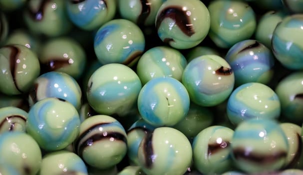 Close-up of many round glass beads in a container.
