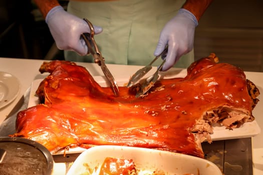 A suckling pig is cut up and portioned.