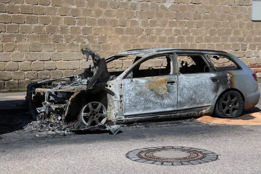 The remains of a passenger car after a vehicle fire.