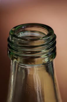 A close-up of the neck of a glass bottle for drinks.