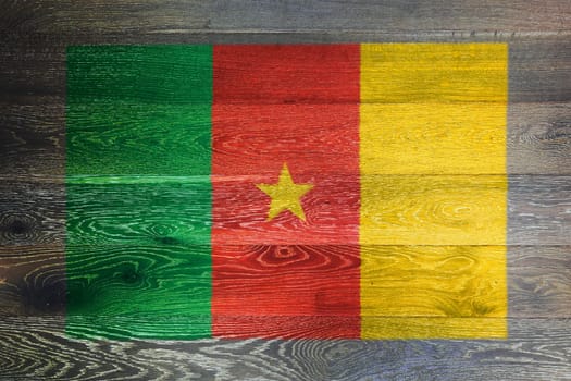 A Cameroon flag on rustic old wood surface background