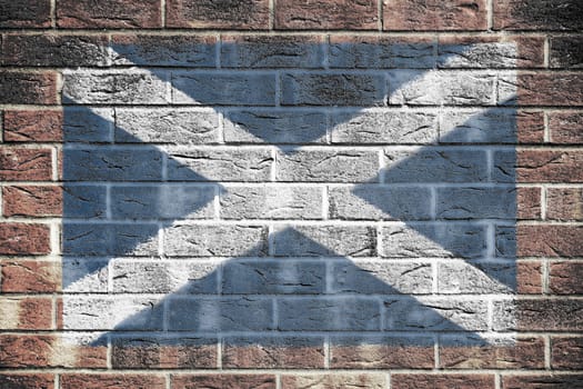 A Scotland flag on a brick wall background cross of Saint Andrew