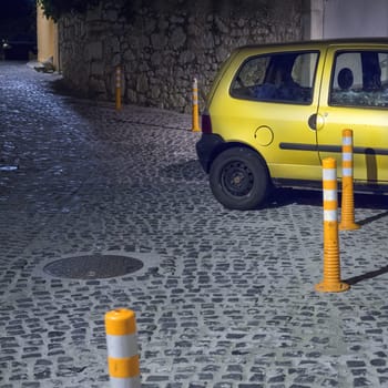 Old yellow car in the night streets of sibenik, croatia