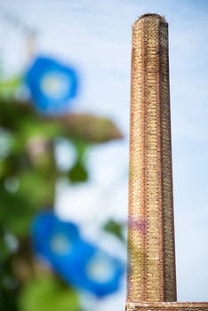 A large old industrial chimney made of red brick