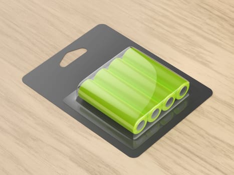 Blister pack of four AA size batteries on wooden desk