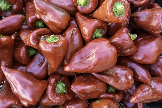 Detail of raw red vegetables in a traditional market in Spain, healthy food and diet, vegan